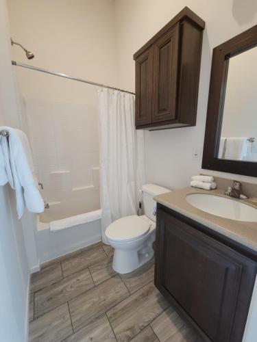a bathroom with a toilet and a sink and a tub at Coachella Lakes RV Resort in Coachella