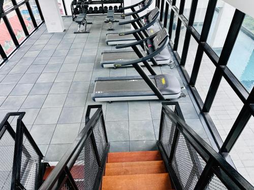 a row of chairs sitting on a balcony at New 2BR or 3BR Homey Getaway stay 7 to 10 pax at Urban Suites, Georgetown by URBAN STAYCATION LOD in Jelutong