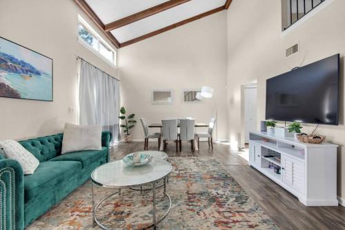 uma sala de estar com um sofá verde e uma televisão em Quiet Home, Perdido-Orange Bch, Golf View 3BR-2BT em Pensacola