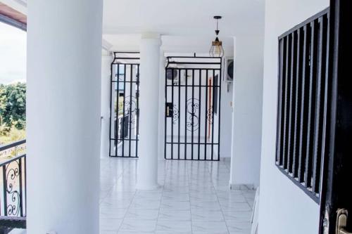 a hallway with two gates in a house at Nancy Real Estate in Limbe
