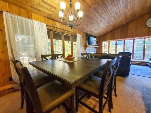 a dining room with a wooden table and chairs at Ocean & Mountain View Duplex, both sides in Juneau