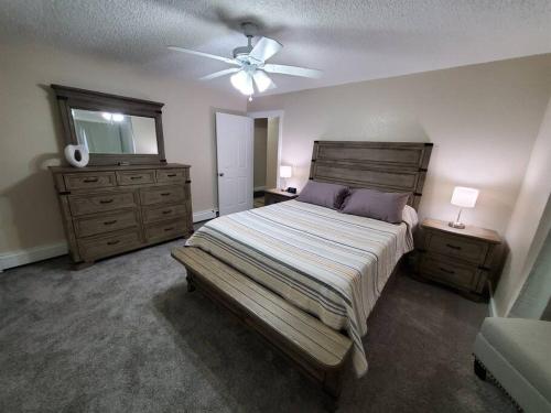 a bedroom with a bed and a ceiling fan at Ocean & Mountain View Duplex, both sides in Juneau