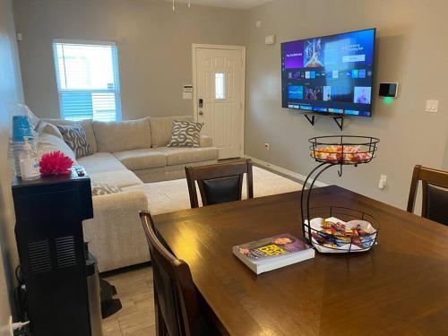 a living room with a table and a tv at Spacious Getaway near UTRGV in Edinburg