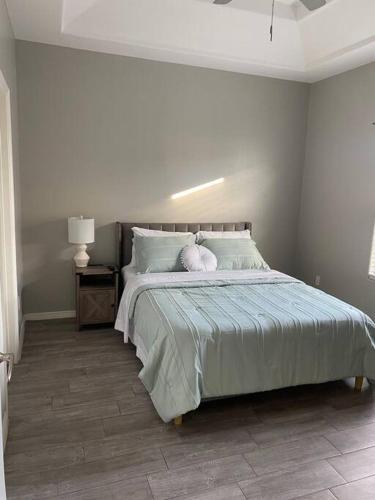 a bedroom with a bed with a stuffed animal on it at Spacious Getaway near UTRGV in Edinburg