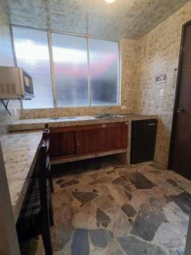 a kitchen with a sink and a counter top at Hotel Suites Teziutlan in Teziutlán