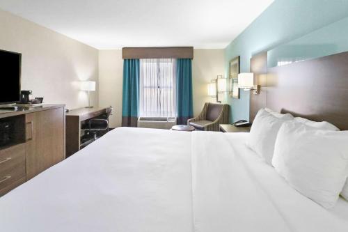 a large white bed in a hotel room at Comfort Inn Dunn near I-95 in Dunn