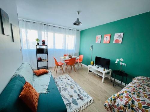 a living room with a bed and a dining room at Le Vibrant Bubble - Studio Parking 10 min U-Arena La Défense in Houilles