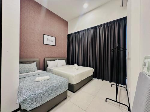 a bedroom with two beds and a black curtain at New 2BR or 3BR Homey Getaway at Urban Suites, Georgetown 7 to 10pax in Jelutong