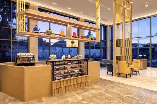 a lobby of a store with a bakery at Courtyard by Marriott Tiruchirappalli in Tiruchchirāppalli