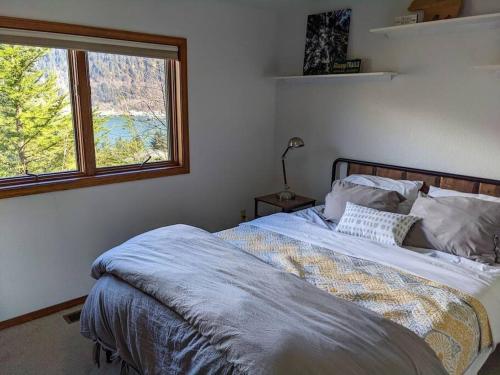 a bedroom with a large bed with a window at Breathtaking Ocean, Mountain & Juneau Views in Juneau