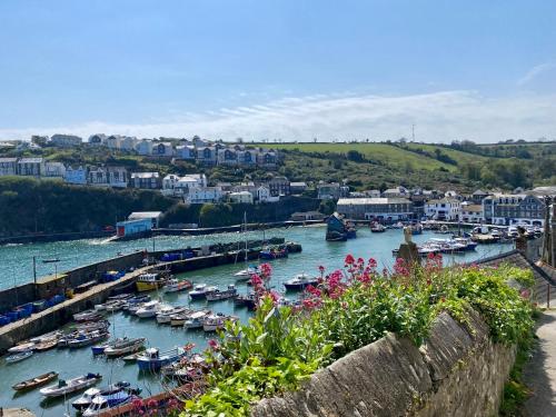 a harbor with boats in the water and buildings at About Time Meva - stylish two-bedroom, dog-friendly home-from-home with parking and garden in Mevagissey