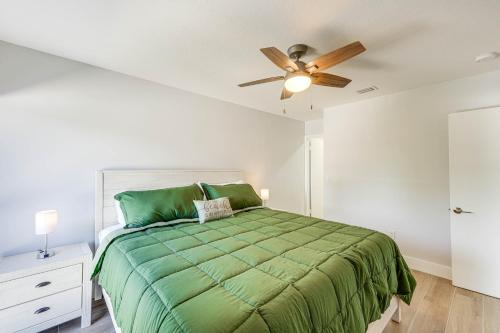 a bedroom with a green bed with a ceiling fan at Laptop-Friendly Key Largo Condo with Pool View! in Key Largo