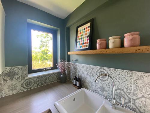 a bathroom with a sink and a window at About Time Meva - stylish two-bedroom, dog-friendly home-from-home with parking and garden in Mevagissey