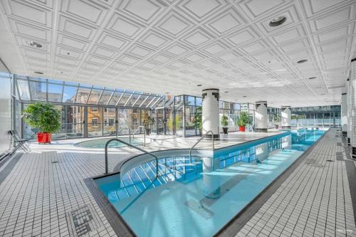 a large swimming pool in a large building at Modern Condo in the Heart of DT Overlooking City in Vancouver