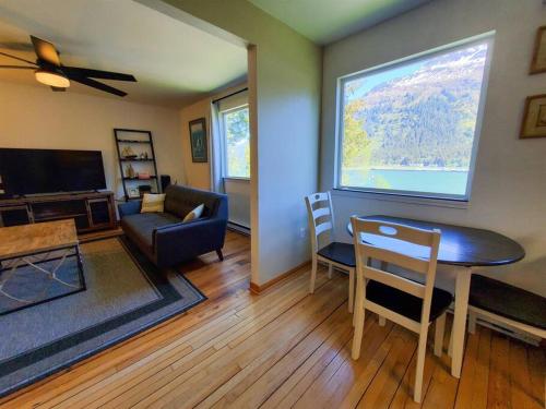 a living room with a table and a couch at Ocean & Mountain View Home, near Downtown Juneau in Juneau
