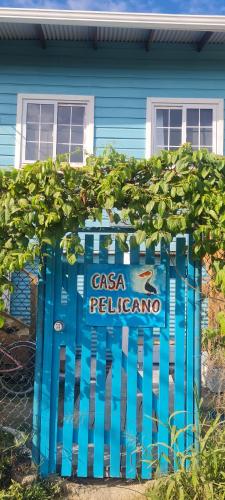 a blue gate in front of a blue house at Casa Pelicano in Bocas del Toro