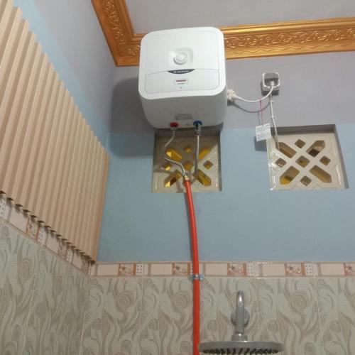 a toilet in the corner of a room at Private Bali Artifac GuestHouse in Singaraja