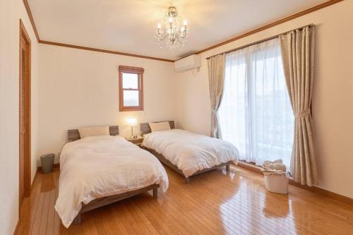 Cama o camas de una habitación en 1棟貸切BBQ可 本格ダーツ かき氷機 Villa上条