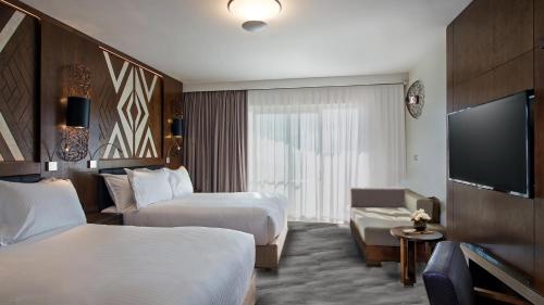 a hotel room with two beds and a flat screen tv at Crowne Plaza Fiji Nadi Bay Resort & Spa by IHG in Nadi