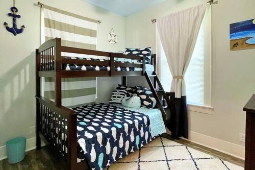 a childs bedroom with a bunk bed in a room at The Poolside Bungalow in Galveston