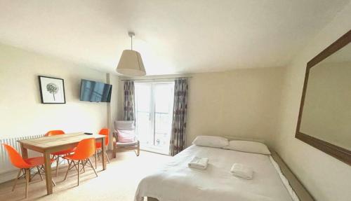 a bedroom with a bed and a table and chairs at Entire Lovely Central London Flat in London