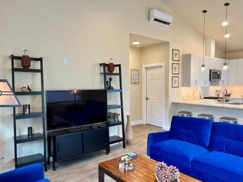 a living room with a blue couch and a kitchen at Brand new everything home! in Sandpoint