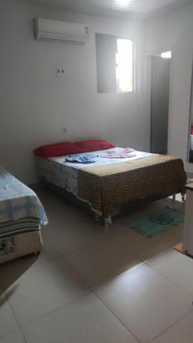 a bedroom with a bed in the corner of a room at Pousada ji Paraná in Ji-Paraná