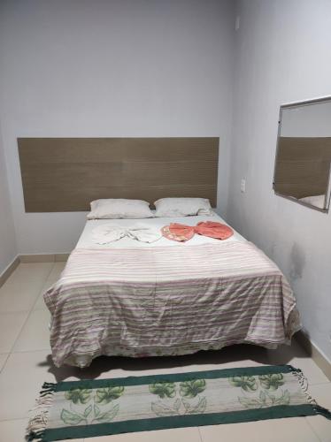 a bed in a bedroom with two towels on it at Pousada ji Paraná in Ji-Paraná