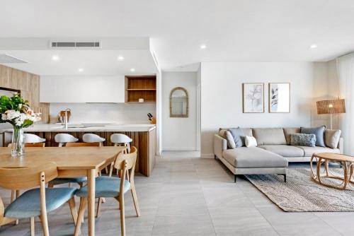 a kitchen and living room with a table and a couch at 2BR Luxury Central Palm Beach Apartment (Best Location!) in Gold Coast