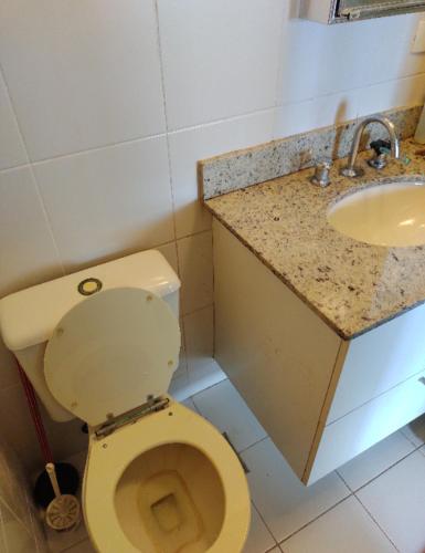 a bathroom with a toilet and a sink at Apato Recreio in Rio de Janeiro