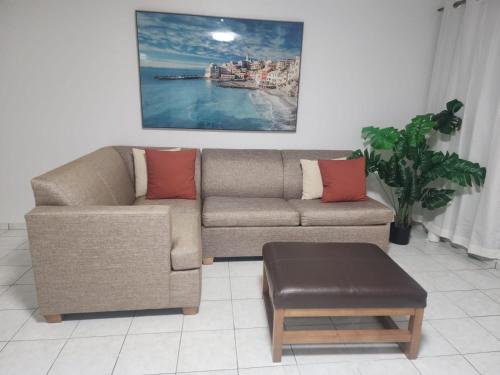 a living room with a couch and a table at San Juan apartments new in San Juan