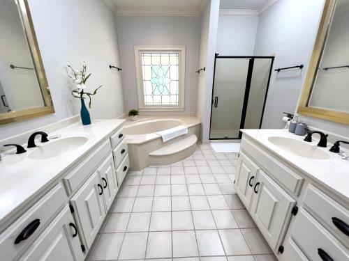 a bathroom with two sinks and a toilet and a tub at 2811 Hawthorne Dr, NE Top Unit in Atlanta