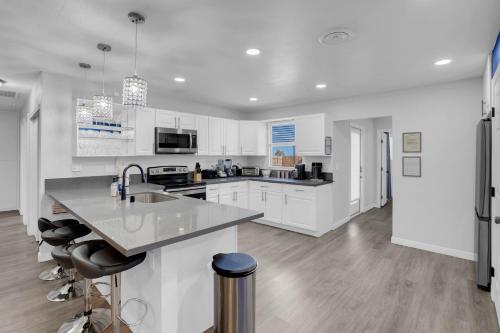 a kitchen with white cabinets and a counter top at Big Group, Remodeled, Landscaped, King Beds, Desks in Las Vegas