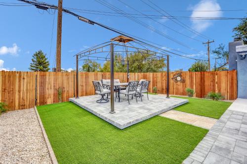 a gazebo with a table and chairs on a lawn at Big Group, Remodeled, Landscaped, King Beds, Desks in Las Vegas