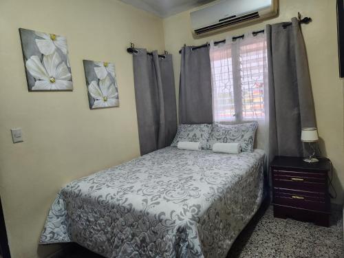 a bedroom with a bed and a window at Casa Altamira in San Pedro Sula