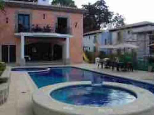 a swimming pool in front of a house at Acogedora casa con firepit in San Juan del Obispo