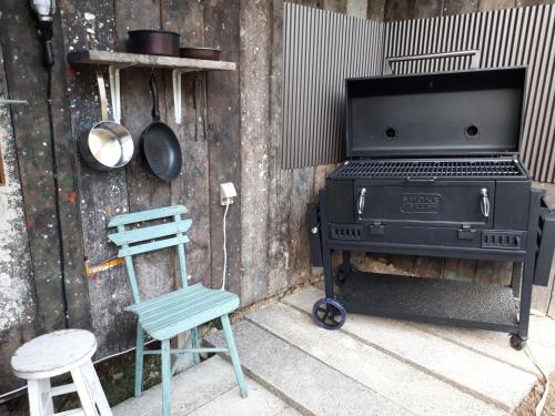 a grill and a chair and a stove and two stools at Private Garden The West - Vacation STAY 41967v in Ōhara