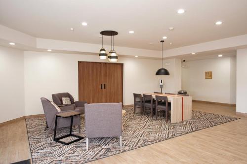 a meeting room with chairs and a table and a podium at Candlewood Suites Roswell by IHG in Roswell