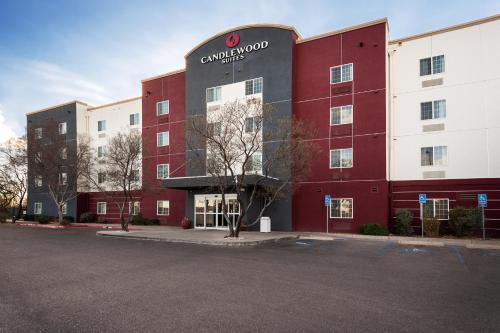 a red and white building with a sign on it at Candlewood Suites Roswell by IHG in Roswell