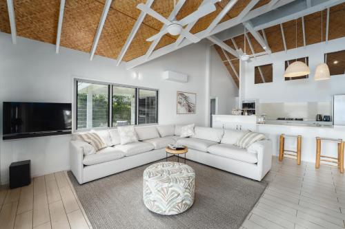 a living room with a white couch and a table at Solwota Sands in Port Vila