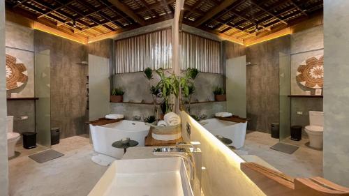 a bathroom with two sinks and two toilets at Leafy Lofts Canggu in Canggu