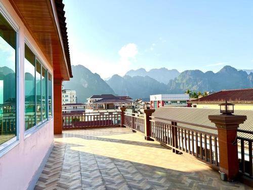 a balcony of a house with a view of mountains at SISAVANG HOTEL in Vang Vieng