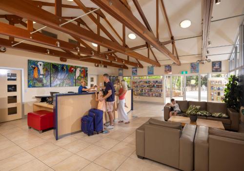 a group of people standing in a store at Ashmore Palms Holiday Village in Gold Coast