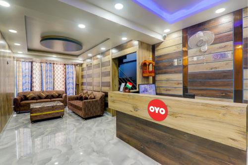 a lobby with a waiting area with a couch and a tv at OYO Flagship Hotel Love Inn in Lucknow