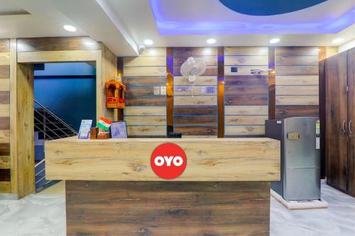 a lobby with a wooden counter with aevo sign on it at OYO Flagship Hotel Love Inn in Lucknow
