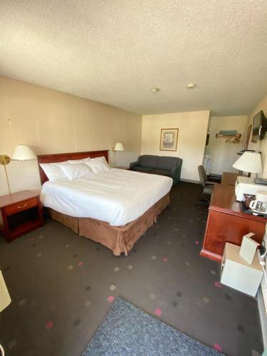 a hotel room with a bed and a desk at Bavarian Inn in Bruce Mines