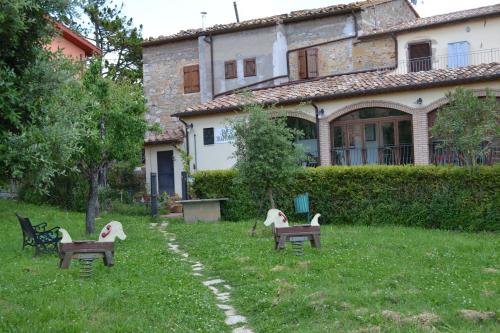 a group of chairs in the grass in front of a house at Da Bianchina in Capanne