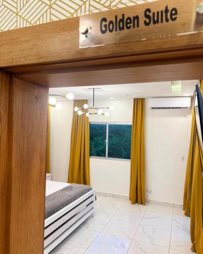a bedroom with a bed and a sign that reads golden suite at 5 Star Villa minutes from Airport and Beaches in Sosúa