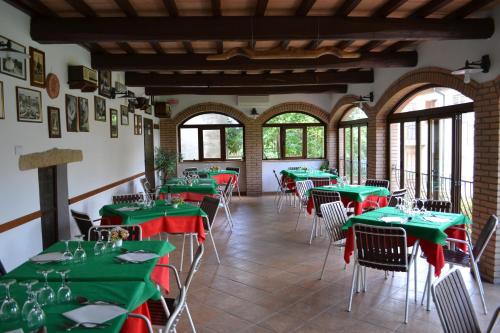 a dining room with green tables and chairs at Da Bianchina in Capanne