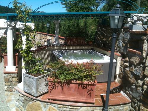 a garden with a hot tub and a street light at B&B Pino del Capitano in Dicomano